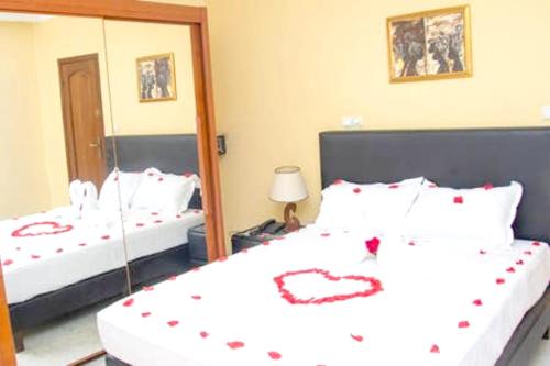 a bedroom with two beds with hearts on them at Appartement spacieux à Kinshasa avec balconELv in Kinshasa