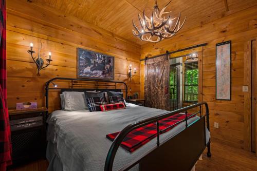 a bedroom with a bed in a room with wooden walls at Dreamy Cabin & Outdoor Oasis! Mins to Nat'l Park! in Townsend