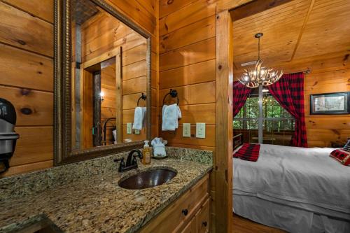 a bathroom with a sink and a bed in a room at Dreamy Cabin & Outdoor Oasis! Mins to Nat'l Park! in Townsend