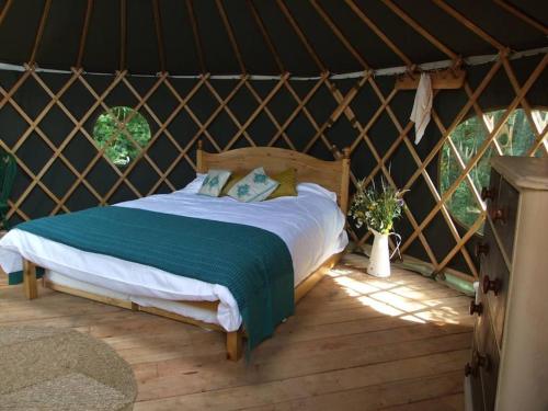 a bedroom with a bed in a yurt at 'Oak' Yurt in West Sussex countryside in Fernhurst