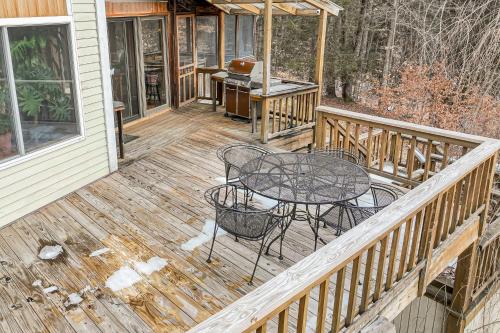 a wooden deck with a table and chairs on it at Newfane Hill Retreat in Newfane