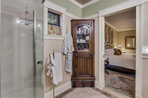 a bathroom with a shower and a glass door at Historic Guard House in Tucson