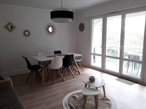 a white living room with a table and chairs at Stella maris in Carnac