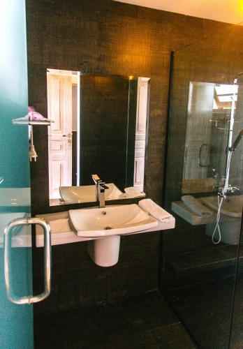 a bathroom with a sink and a shower at Naomi Beach Resort - Adults only in Weligama