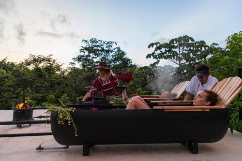 a group of people sitting in a wheelbarrow at Glass House in Puerto Morelos
