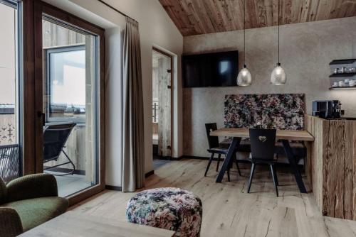 a kitchen and dining room with a table and chairs at Biohof Ebengut in Maria Alm am Steinernen Meer