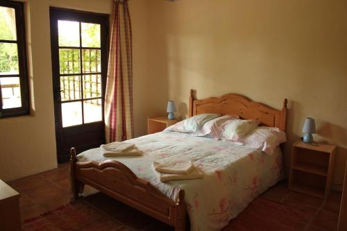 a bedroom with a bed with two towels on it at Gîtes de Peyrounou in Lacapelle-Biron