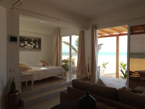 a bedroom with a bed and a view of the beach at Villa Cristina Alojamento, Praia de Chaves, Boa Vista, Cape Verde, WI-FI in Sal Rei