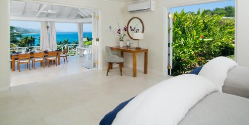 a bedroom with a view of the ocean at Round Hill Hotel & Villas in Montego Bay