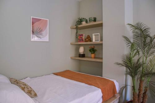 a bedroom with a bed and a potted plant at BIRD NEST Near Arkan Plaza in Cairo