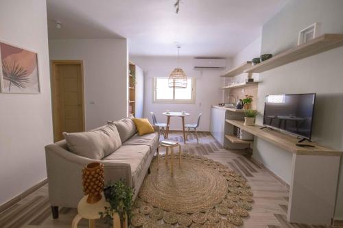 a living room with a couch and a dining room at BIRD NEST Near Arkan Plaza in Cairo