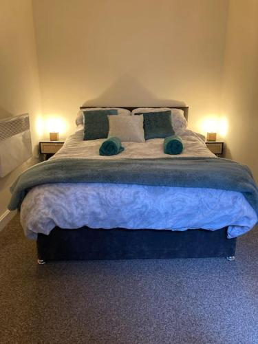 a bedroom with a large bed with two pillows at Winter Gardens North Pier Home in Blackpool