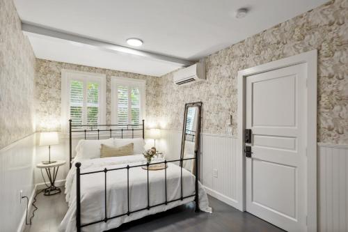 a bedroom with a bed and a white door at The Stirrup House by Pattio in Miami