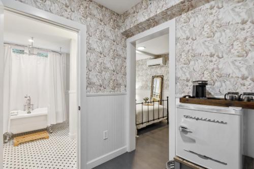 a bathroom with a sink and a bath tub at The Stirrup House by Pattio in Miami