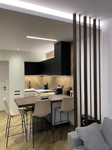 a kitchen with a table and chairs in a kitchen at Luxury Apartment in Akrata