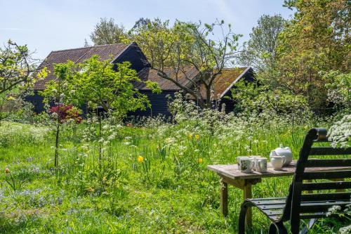 a table in the middle of a field of grass at Vibrant rural hideaway - Aspen Loft in Sudbury