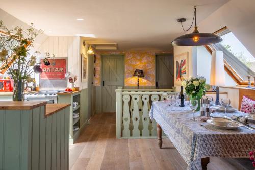 a kitchen with a table with a table cloth on it at Vibrant rural hideaway - Aspen Loft in Sudbury