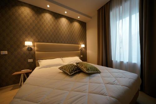 Postel nebo postele na pokoji v ubytování Hotel Valle del Fiora