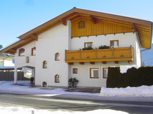 a large white building with a wooden balcony at Appartement Pichler in Radstadt