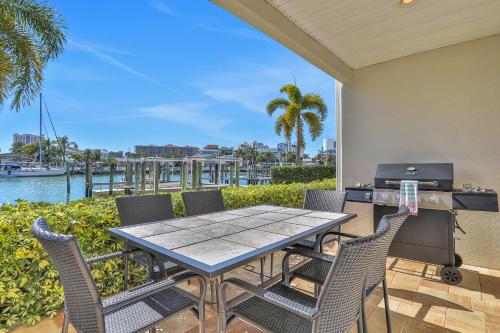 a patio with a table and chairs and a grill at Bayfront Bounty in Clearwater Beach
