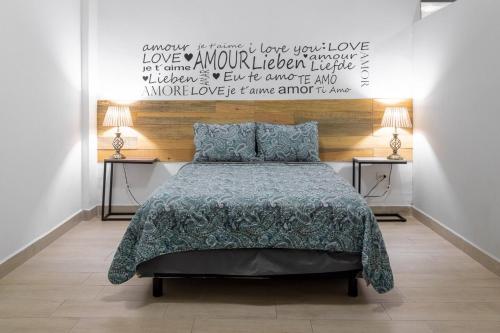 a bedroom with a bed and two tables with lamps at Nuevos departamentos (6) centro histórico a 200 mta malecón in La Paz