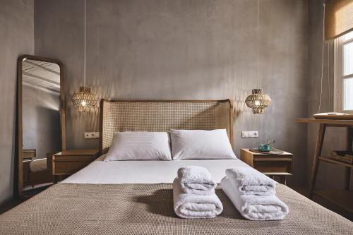 a bedroom with a bed with towels on it at Villa Gallis in Pollonia
