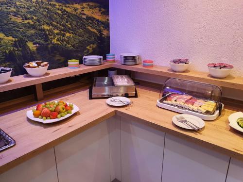 a buffet with a plate of food on a counter at Hotel Exquisite in Bobenheim am Berg
