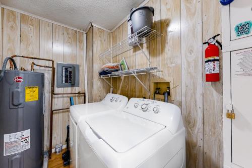 a washer and dryer in a room with wooden walls at Bethany Meadows - 4E Briar N in Frankford