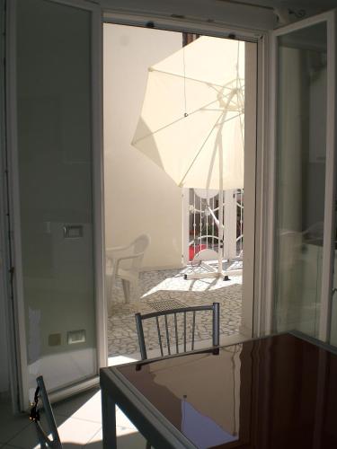 a view of a patio with an umbrella through a window at Residence Teresines in Porto Garibaldi