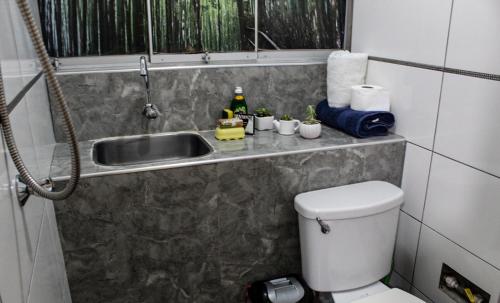a small bathroom with a sink and a toilet at Casa Leon 5 min away from the Airport in Lima