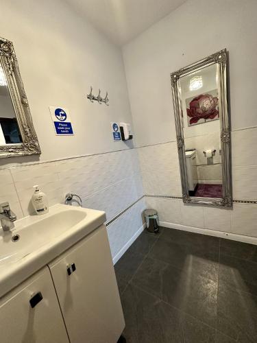 a bathroom with a sink and a mirror at Heathwood in Dover