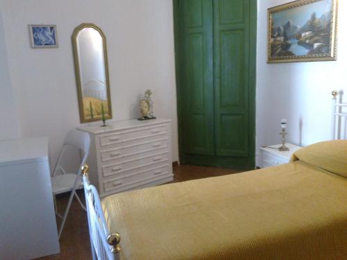 a bedroom with a bed and a mirror and a dresser at La taverna in Sessa