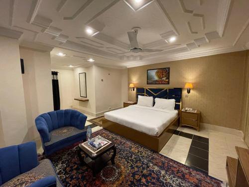 a large hotel room with a bed and a couch at Arya Hotel Islamabad in Islamabad