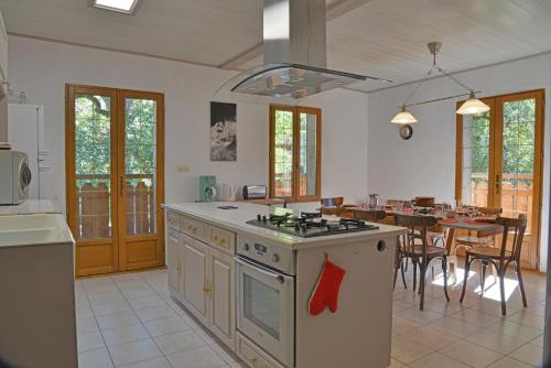 Il comprend une cuisine équipée d'une cuisinière et d'une salle à manger. dans l'établissement Appartement dans chalet 5 chambres 130 m2 centre village, à Montriond