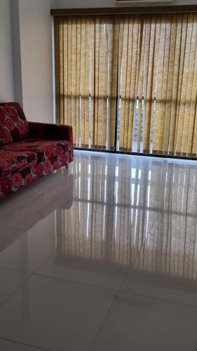 a couch sitting in a room with a window at Apartamento Centro Manaus Hotel Saint Paul - 5º Andar - Apto 1055 in Manaus