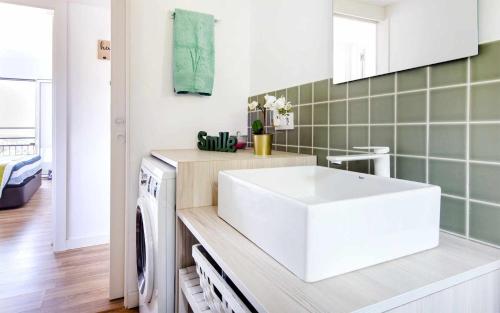 a kitchen with a sink and a washing machine at Codolar Las mejores vistas en Tossa de Mar in Tossa de Mar