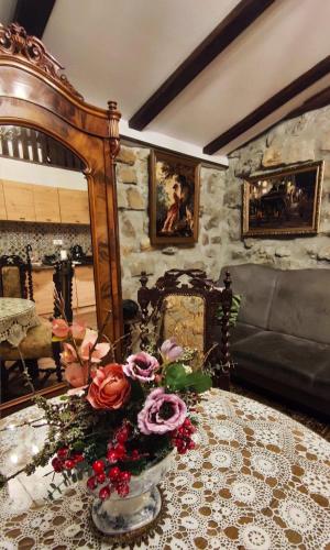 a living room with a table with flowers on it at Chata Kataryniarza in Karłów