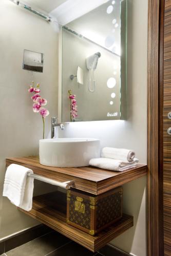 a bathroom with a sink and a mirror at Hotel Unicorno in Florence