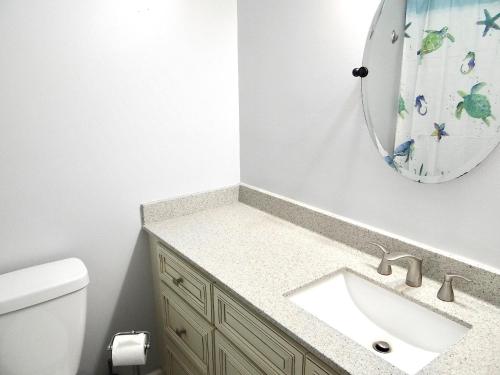 a bathroom with a sink and a mirror at 17A GCR Lovely 2 bed Condo with pool in Surfside in Myrtle Beach