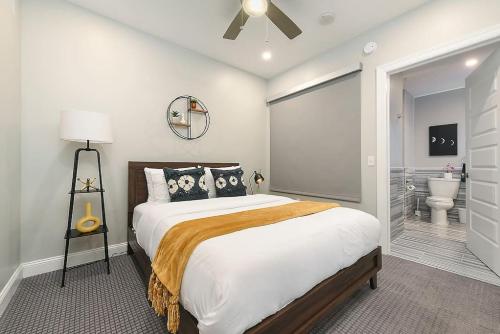 a bedroom with a large bed and a bathroom at HostWise Stays - The Washington at Chatham - Free Garage Parking across from PPG Arena in Pittsburgh