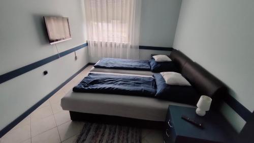 Cama o camas de una habitación en NikoLux Apartman