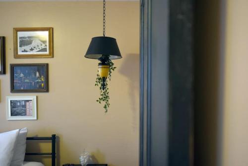 a lamp hanging from a wall in a bedroom at HostWise Stays - The Ocala - Free Parking, Cool Space, Spiral Stairs in Pittsburgh