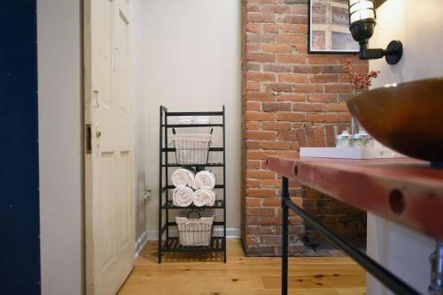 a bathroom with a black rack with towels at HostWise Stays - The Ocala - Free Parking, Cool Space, Spiral Stairs in Pittsburgh