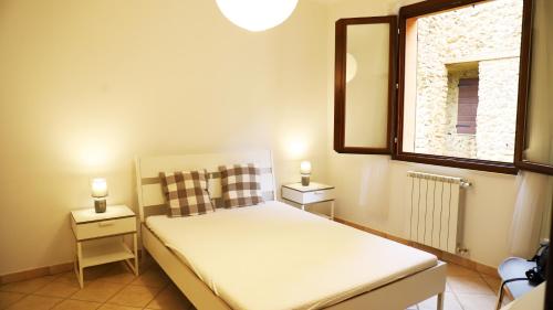 sypialnia z łóżkiem, lustrem i oknem w obiekcie Casa Nadia w mieście Guardistallo