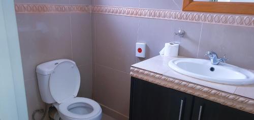 a bathroom with a white toilet and a sink at Sweet Home39 Guest House Summerstrand in Port Elizabeth