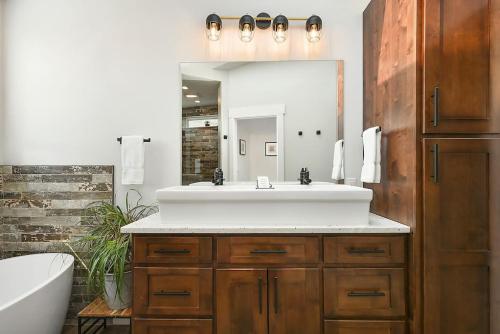 a bathroom with a sink and a mirror at HostWise Stays - The Larryville - Amazing Bathroom, Perfect Location, Custom Build in Pittsburgh