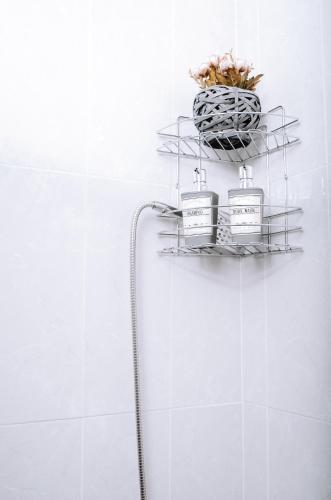 a shelf with four bottles ofodorizers on a wall at Villa Sea Breeze in Karpathos