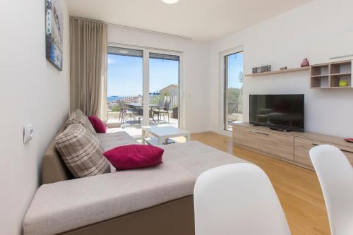 a living room with a couch and a television at Royal Primošten in Primošten