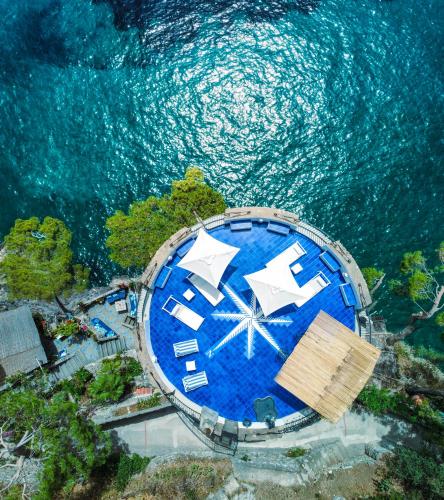 an overhead view of a large swimming pool next to the water at Villa Torre Trasita luxury suites in Positano