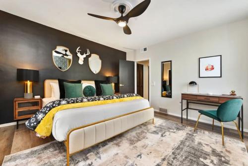 a bedroom with a large bed and a desk at HostWise Stays - Grandview Balcony with Stunning Skyline Views in Pittsburgh
